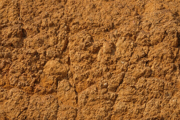 The surface of the dry land is covered with abstract patterns, shapes and textures. Excavated land. The soil looks fragile and is prone to landslides