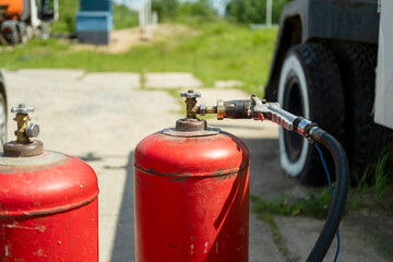 Gas cylinders are connected to a gas supply hose, filled with gas .