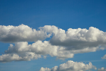 Cumulus clouds. White clouds on the blue sky close-up.