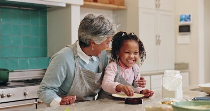 Baking, fun and granny teaching girl how to prepare dough or pastry in kitchen of home together. Child development, food or playful family with senior woman and grandchild in apartment for lesson