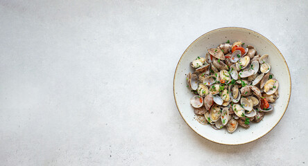 Fresh steamed shellfish with white wine, garlic and parsley, top view, copy space