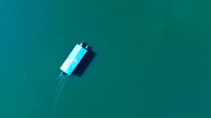 Aerial view, wooden ship crossing the river in Makassar City