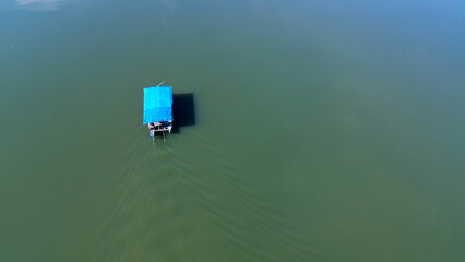 Aerial view, wooden ship crossing the river in Makassar City
