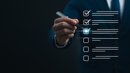 Performance checklist and tracking business performance, businessman using pen to mark checkboxes, conducting audits Evaluation questionnaire Survey via online digital form.