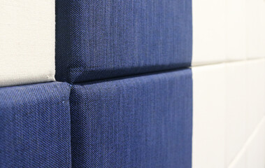 Close-up blue and white fabric acoustic panel pattern texture.