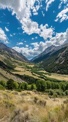 Fototapeta premium Scenic mountain valley with lush greenery and a blue sky.