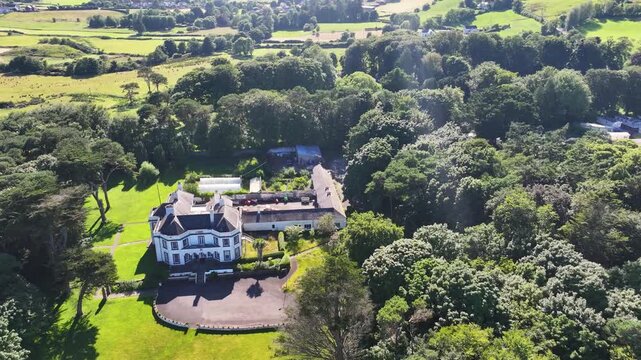 Aerial View of Glenmona House Cushendun on the Irish Sea Co Antrim Northern Ireland on a sunny day with a blue sky 27-07-24