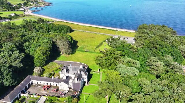 Aerial View of Glenmona House Cushendun on the Irish Sea Co Antrim Northern Ireland on a sunny day with a blue sky 27-07-24