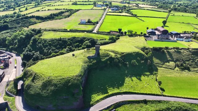 Aerial View of Red Bay Castle Cushendall Waterfoot on the Irish Sea Co Antrim Northern Ireland on a sunny day with a blue sky 
