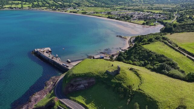 Aerial View of Red Bay Castle Cushendall Waterfoot on the Irish Sea Co Antrim Northern Ireland on a sunny day with a blue sky 