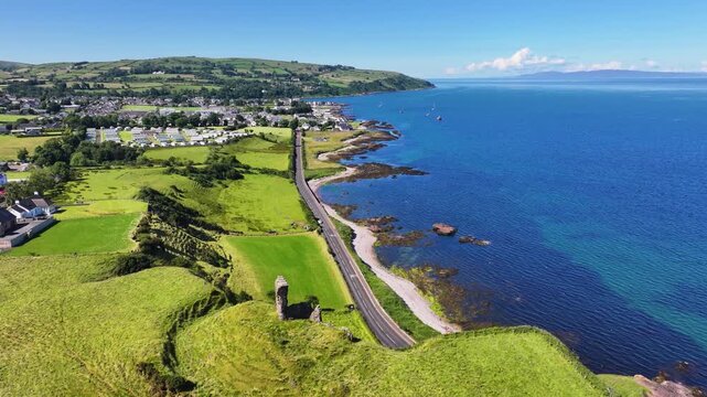 Aerial View of Red Bay Castle Cushendall Waterfoot on the Irish Sea Co Antrim Northern Ireland on a sunny day with a blue sky 
