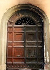 Old wooden door in old town of Bologna, Italy.