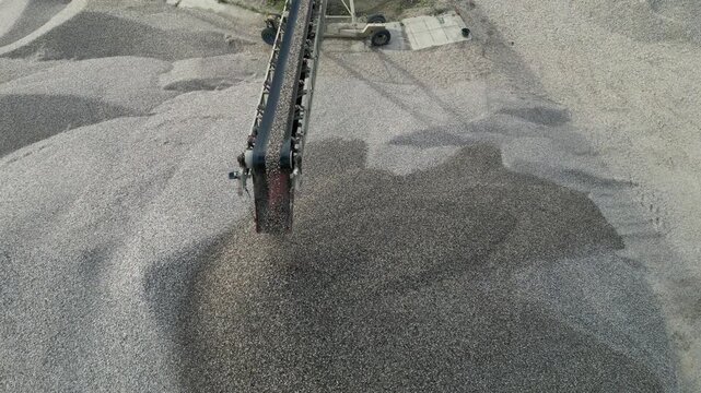 sorting and separation line for separating sand from pebbles and gravel. the conveyor pours large piles for transport to the construction site or to the concrete plant