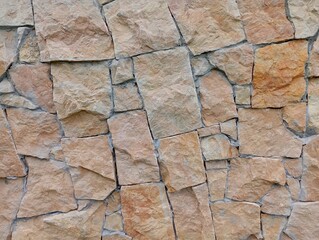 A wall of brown sandstone. The texture of a wall lined with natural stones.