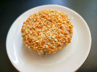 photo of peanut donuts on a white round plate