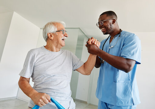 therapist senior man exercise exercising patient physical therapy care nurse recovery physiotherapy fitness stretching stretch band elderly support training