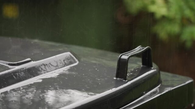 Refuse Bin being pelted with Rain During a Thunderstorm with Audio