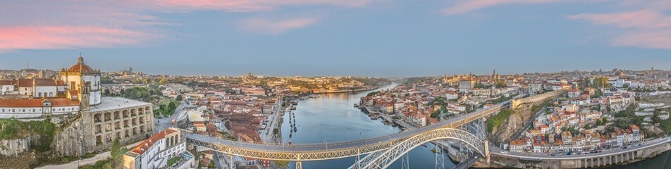 Fototapeta premium Drone panorama over the city of Porto and the Douro River at sunrise