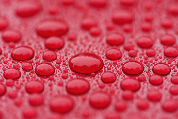 Closeup waterdrops on red ceramic coated paint surface