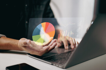 person using a laptop with floating pie charts and graphs. It represents data analysis, business intelligence, and the use of visual tools for better understanding and decision-making.