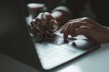 Laptop with digital icons for email, chat, and user profiles hovering above. It represents the...