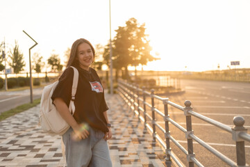 Teen girl with long hair at sunset in the city