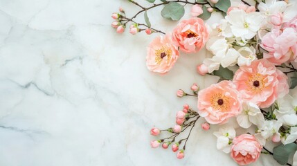 A beautiful floral arrangement displays soft pink and white flowers elegantly placed on a smooth marble surface