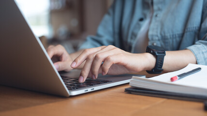 Woman typing on laptop computer, working at coffee shop. Business woman working on laptop, surfing...