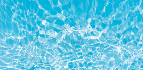 Blue water with ripples on the surface. Defocus blurred transparent blue colored clear calm water surface texture with splashes and bubbles. Water waves with shining pattern texture background.