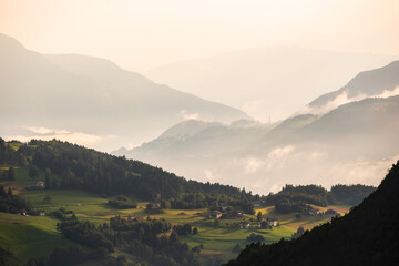 Misty Valleys Under a Soft Dawn Light in the Majestic Mountains