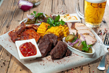 kebab with baked vegetables on pita bread served with a glass of beer