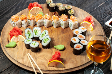 large sushi set on a round plate, macro photo