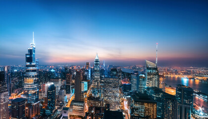 Obraz premium Cityscape of a metropolis at night, showcasing urban life, skyscrapers, city lights, modern architecture, bustling city, and metropolitan atmosphere.
