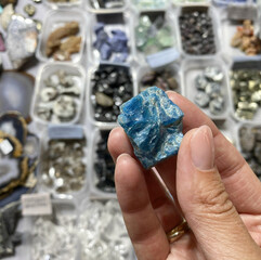 blue apatite in the girl's hand. Exhibition of stones, exclusive, sale, trade, selection. Fair, Good buy, Mining, valuable apatite stone, collectible mineral.