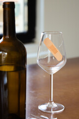 Broken glass of wine. Sadness after the breakup. Tape on the glass