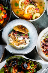 Assorted gourmet dishes with fresh ingredients, colorful presentation, and artistic plating. High-end restaurant cuisine showcasing vibrant colors, emphasizing culinary artistry and elegance.