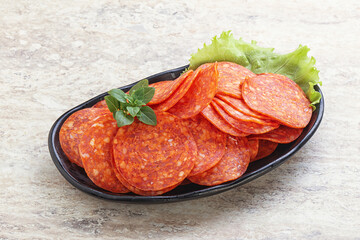Sliced pepperoni sausage in the bowl