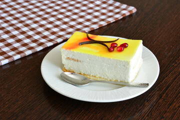 a slice of lemon cake with a spoon on a plate next to it  