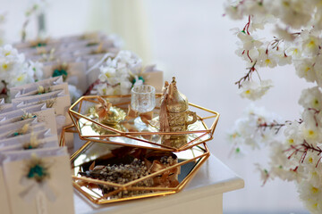 Rustic chic wedding favors with dried flowers and gold accents on a mirrored tray