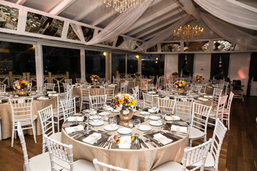 Romantic Dinner Setup: Table with Sunflower Bouquet and Cityscape at Night