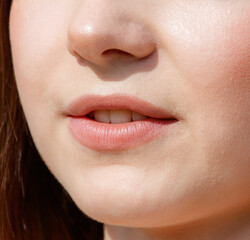Obraz premium Close-up of lips on a girl's face. Macro