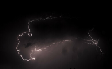 An eerie landscape with a lightning discharge of a mysterious shape