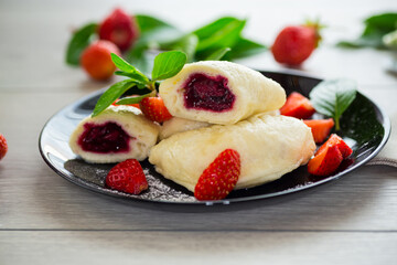 cooked sweet homemade steamed dumplings with strawberries