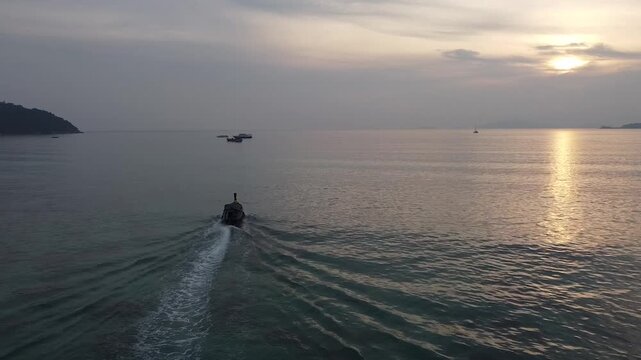 drone footage of fishing boat at north point beach in koh lipe thailand