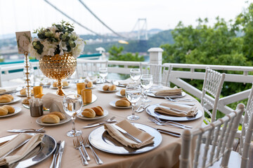Elegant Wedding Table Setting with City View and Bridge in the Background