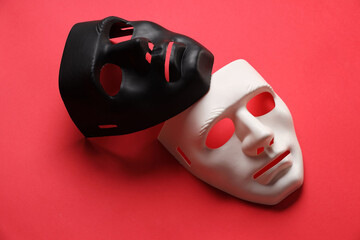 Theater arts. White and black masks on red background
