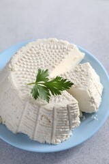 Tasty ricotta (cream cheese) on grey table