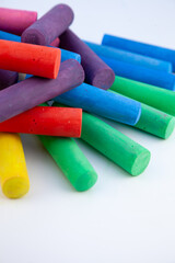 Set of colorful chalks for the board and the street. Drawing chalk stick, back to school background. Heap draw equipment. Kids craft