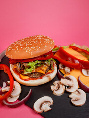 delicious burger with a white sesame bun, a juicy patty, fresh green vegetables, tomato, and cheese on a beautiful pink background