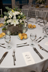 Beautiful wedding reception table arrangement with blush pink linens, white chairs, floral...